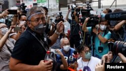 FILE - Ronson Chan, chairman of the Hong Kong Journalists Association (HKJA), is seen as he reports to police, in Hong Kong, Sept. 19, 2022.