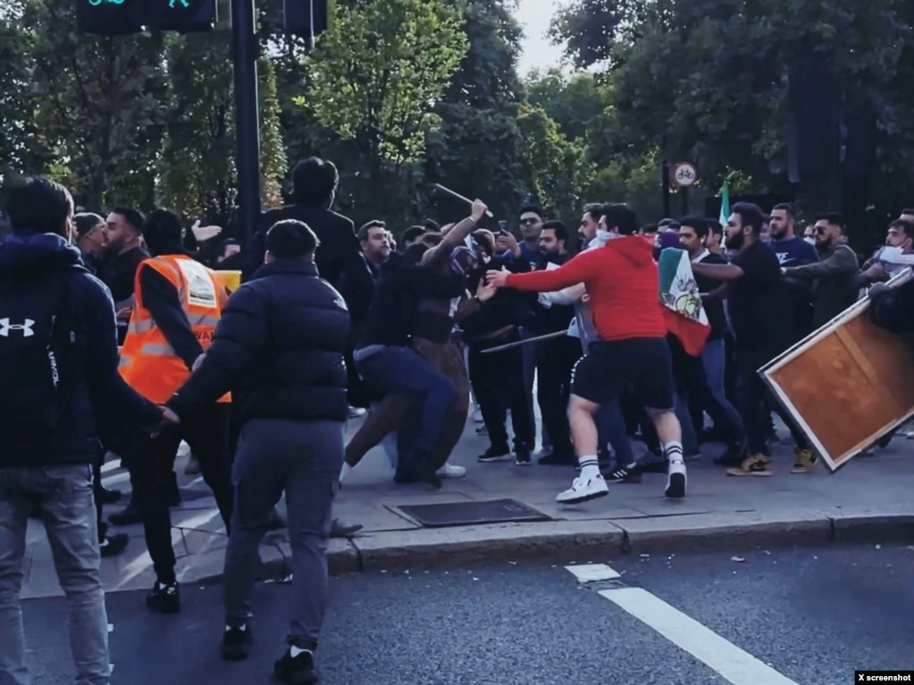 Protesters clash during demonstrations following the death of Mahsa Amini in Iran, in London, on Sept. 25, 2022, in this screen grab obtained from social media video. Twitter @PaulBrown_UK/via REUTERS.