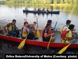 International students canoe down the Stillwater River near the University of Maine campus in Orono, Maine.