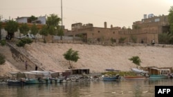 FILE - The Tigris river flows in the central Karkh district of the Iraqi capital Baghdad on on July 24, 2022.