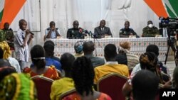 FILE - Ivory Coast's Minister of defense Tene Birahima Ouattara (3rd), Ivorian Army chief of staff, general Lassina Doumbia (4thL) and Generals address the relatives of the 49 Ivorian soldiers detained in Mali, in Abidjan on August 3, 2022. 