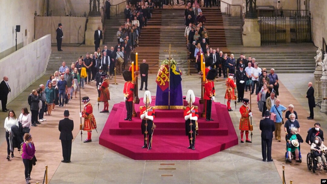 The first members of the public pay their respects as the vigil begins around the coffin of Queen Elizabeth II in Westminster Hall, London, Sept. 14, 2022, where it will lie in state ahead of her funeral on Monday.