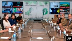 In this photo released by Pakistan's National Flood Response Coordination Centre, U.N. humanitarian Angelina Jolie, second left, attends a meeting with Pakistani officials about the damage caused by floods, in Islamabad, Pakistan, Sept. 21, 2022.