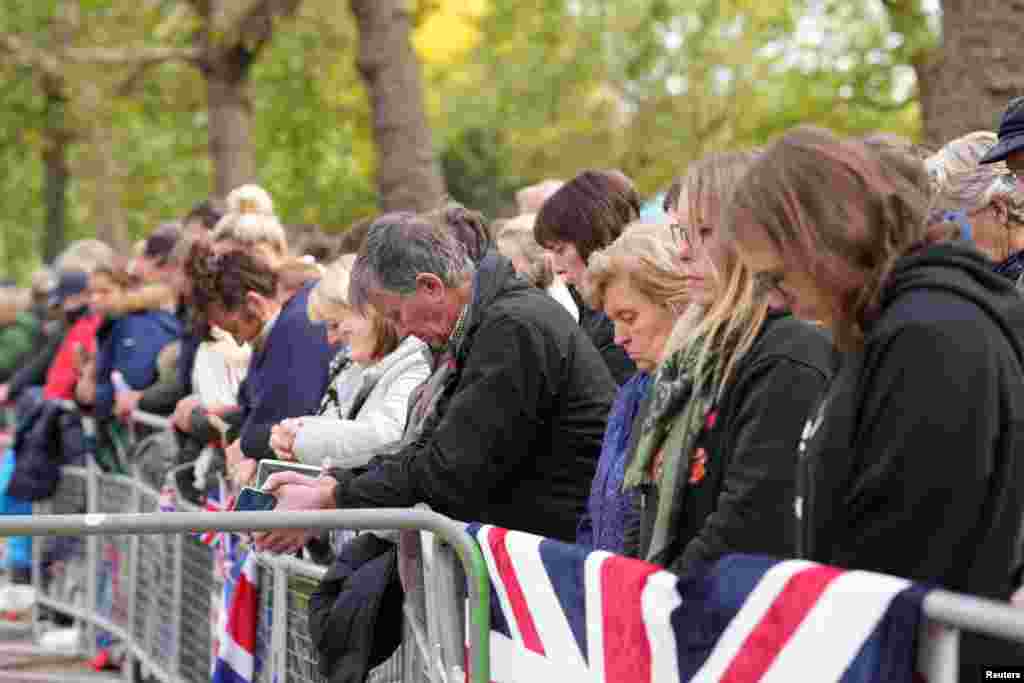 People observe the minute of silence on the day of the state funeral and burial of Queen Elizabeth, in London, Sept. 19, 2022.