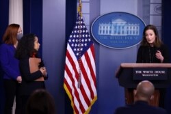 White House Press Secretary Jen Psaki and Chief of Staff to the First Lady Julissa Reynoso watch as Executive Director of the Gender Policy Council Jennifer Klein delivers remarks during a daily press briefing at the White House, March 8, 2021.