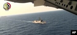 In this video image released by the Egyptian Defense Ministry, an Egyptian plane flies over an Egyptian ship during the search in the Mediterranean Sea for the missing EgyptAir flight 804, May 19, 2016.