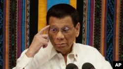 Philippine President Rodrigo Duterte gestures during his 4th State of the Nation Address at the 18th Congress at the House of Representatives in Quezon city, metropolitan Manila, Philippines July 22, 2019. (AP Photo/Aaron Favila)