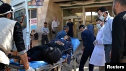 A woman affected by what activists say was a gas attack in the town of Telminnes is transferred to Bab al-Hawa hospital to receive treatment, April 21, 2014.