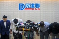 Candidates from pro-Beijing political party bow to apologize for their defeat in the local district council election in Hong Kong, Monday, Nov. 25, 2019.