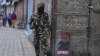 An Indian soldier stands guard during a lockdown in Srinagar, Nov. 5, 2019.