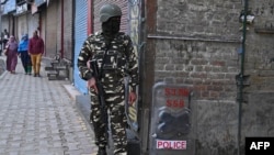 An Indian soldier stands guard during a lockdown in Srinagar, Nov. 5, 2019.