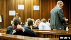 South African Olympic and Paralympic athlete Oscar Pistorius sits in the dock during his murder trial in the North Gauteng High Court in Pretoria, South Africa, May 8, 2014. 