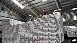 Workers piling sacks of rice at a government rice warehouse in Manila (file photo)