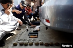 Members of the bomb disposal unit, checking the explosives recovered from a bag, after an attack on the Chinese consulate, in Karachi, Pakistan, Nov. 23, 2018.