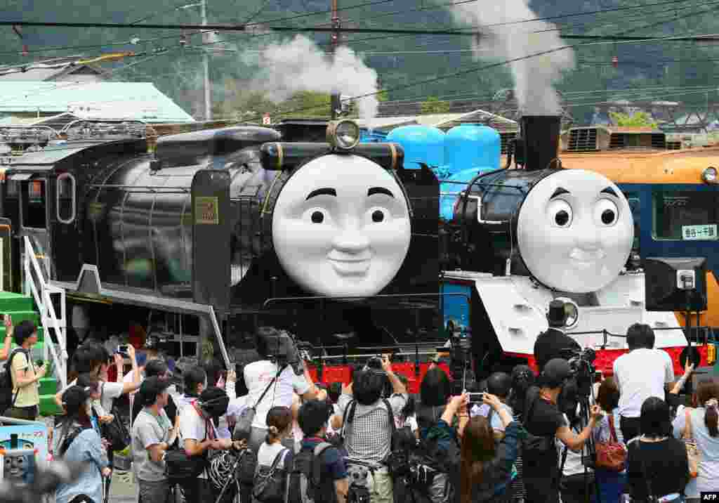 Fife-sized Thomas the Tank Engine (R) and Hiro (L) are surrounded by the media, at Senzu station on Japan&#39;s Oigawa railway, in the town of Kawanehon in Shizuoka prefecture, west of Tokyo. Rides on popular British character Thomas the Tank Engine will be offered to the public from July 12 through Oct. 12 between Shinkanaya and Senzu stations.