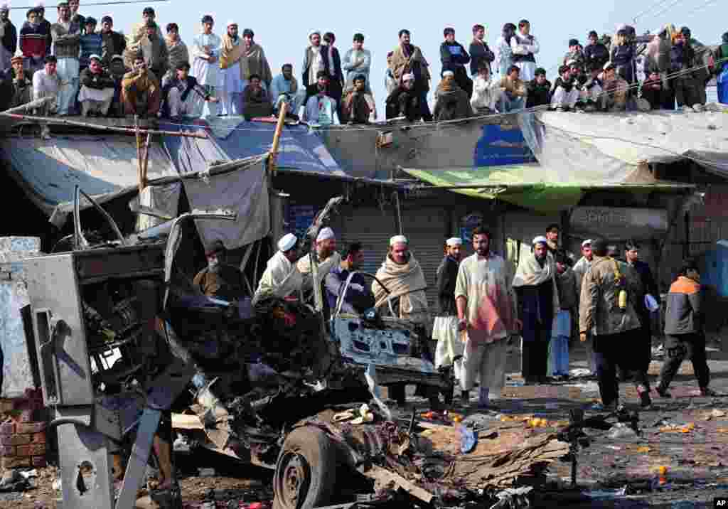 Pakistani local residents gather at the site of a bomb blast in Jamrud, January 10, 2012. (AFP)