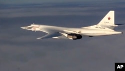 FILE - In this photo made from video taken from Russian Defense Ministry official website on Friday, Nov. 20, 2015, a Russian air force Tu-160 bomber flies a combat mission as part of a Russian air campaign against targets in Syria.