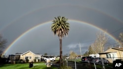 A double rainbow arcs over a palm tree in Santa Rosa, California on February 15, 2019. If you look for a pot of gold at the end of it, you probably will be disappointed. (AP Photo/Josh Edelson)