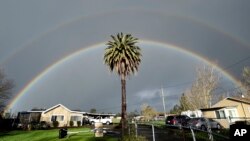 A double rainbow arcs over a palm tree in Santa Rosa, California on February 15, 2019. If you look for a pot of gold at the end of it, you probably will be disappointed. (AP Photo/Josh Edelson)