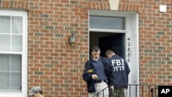 FBI Investigators leave the home of Farooque Ahmed in Ashburn, Va. Ahmed, a naturalized citizen born in Pakistan was arrested Wednesday and charged with trying to help people posing as al-Qaida operatives planning to bomb subway stations around the nation