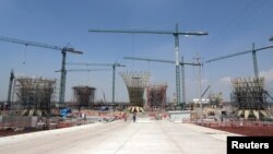 Employees are pictured near on the terminal area at the construction site of the new Mexico City International Airport in Texcoco on the outskirts of Mexico City, Mexico, Aug. 16, 2018. 