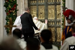 Pope Francis opens the Holy Door to mark the opening of the 2025 Catholic Holy Year, or Jubilee, in St. Peter's Basilica at the Vatican, Dec. 24, 2024.