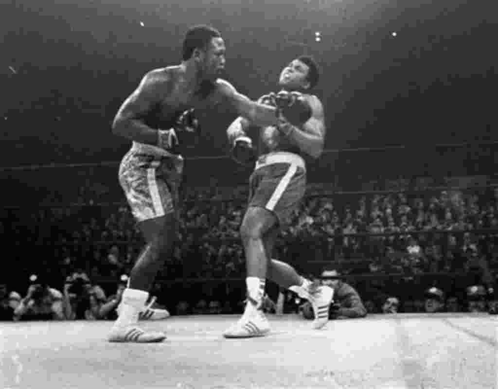 FILE - In this March 8, 1971, file photo, boxer Joe Frazier, left, hits Muhammad Ali during the 15th round of their heavyweight title fight at New York's Madison Square Garden. Former heavyweight champion Joe Frazier is seriously ill with liver cancer. Hi