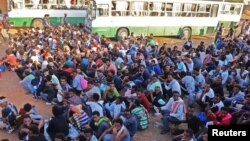 FILE - Migrants are seen after they were relocated from government-run detention centers, after getting trapped by clashes between rival groups in Tripoli, Libya, Sept. 4, 2018.