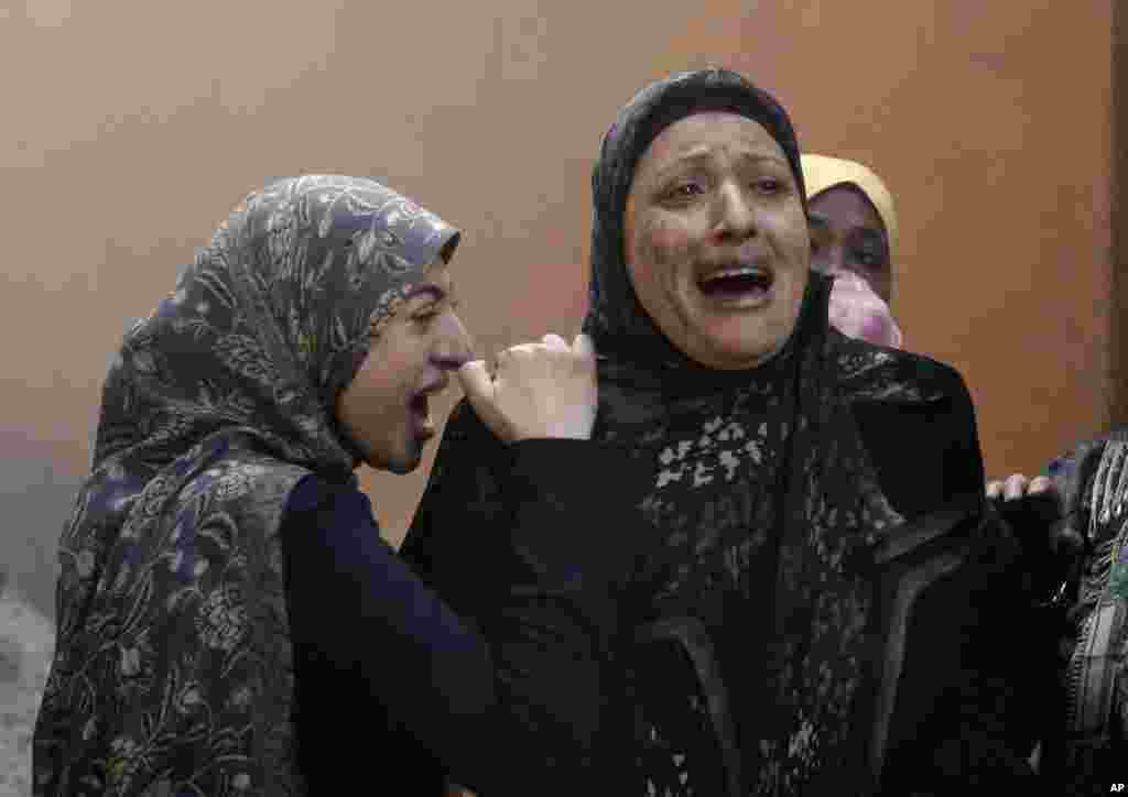 Women who left their destroyed home cry out after a car bomb explosion in a southern suburb of Beirut, Jan. 2, 2014.