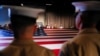 FILE - Army members hold the U.S. flag as they attend an annual Memorial Day ceremony at the Intrepid Museum in New York, May 29, 2017. The Pentagon has just revised a program that enables foreign-born military recruits to earn a fast-track path to American citizenship.