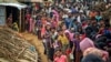 FILE - Rohingya Muslims, who from Myanmar into Bangladesh, wait in queues to receive aid at Kutupalong refugee camp in Ukhiya, Bangladesh, Nov. 15, 2017. 