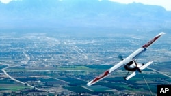 FILE - A Cessna 182 tows a glider plane.