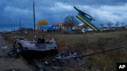 A destroyed armored vehicle lies at the entrance of Kherson, southern Ukraine, Nov. 16, 2022.