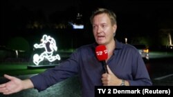Denmark TV 2 reporter Rasmus Tantholdt's live broadcast from the streets of Doha is interrupted by Qatar security staff, Nov. 15, 2022. (TV 2 Denmark via Reuters)