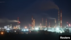 FILE: A view shows a local oil refinery in Omsk, Russia. Many economies are dependent upon oil production and sales, and a "green economy" diminishes that revenue stream. Taken June 6, 2022