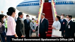 Thailand's Prime Minister Prayuth Chan-ocha and his wife Naraporn Chan-ocha, left, welcome Chinese President Xi Jinping, center, and his wife Peng Liyuan as they arrive at Suvarnabhumi International Airport, Nov. 17, 2022, in Bangkok, for the APEC summit. (Thailand Government Spokesman's Office via AP)