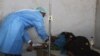 A health worker assists a cholera patient at Limbe Clinic in Blantyre, Malawi. (Lameck Masina/VOA)

