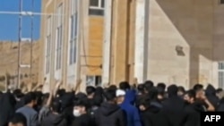 This grab taken from a UGC video made available on the ESN platform on Nov. 15, 2022, reportedely shows Iranian students chanting slogans at the Kermanshah university in support of the protest movement in western Iran's city of Kermanshah.