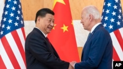 FILE - U.S. President Joe Biden, right, and Chinese President Xi Jinping shake hands before a meeting on the sidelines of the G20 summit meeting on Nov. 14, 2022, in Bali, Indonesia. 
