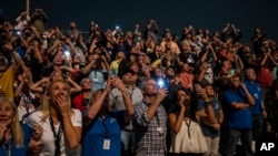 In this photo provided by NASA, visitors at the Banana Creek Launching Area watch the launch of NASA's Space Launch System rocket carrying the Orion spacecraft on the Artemis I flight test, Nov. 16, 2022, at NASA's Kennedy Space Center in Florida. (Keegan Barber/NASA via AP)