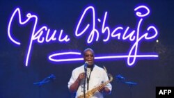 FILE - In this file photo taken on June 30, 2018 Cameroon jazz saxophonist Manu Dibango performs during a concert at the Ivory Hotel in Abidjan.