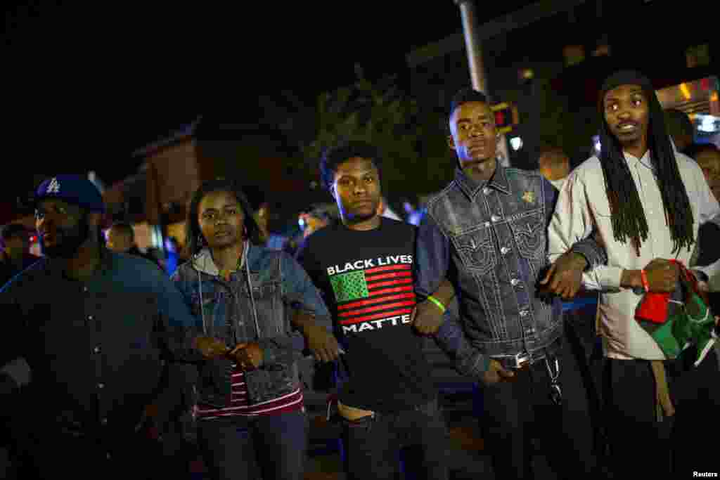 Protestors line up shortly before the deadline for a city-wide curfew at North and Pennsylvania Avenues in Baltimore, April 30, 2015.