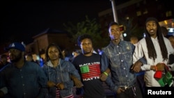 Des manifestants à Baltimore, où un autre défilé est prévu le 1er mai (Reuters)