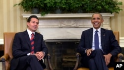 President Barack Obama, right, meets with Mexican President Enrique Pena Nieto, left, in the Oval Office of the White House in Washington, July 22, 2016.