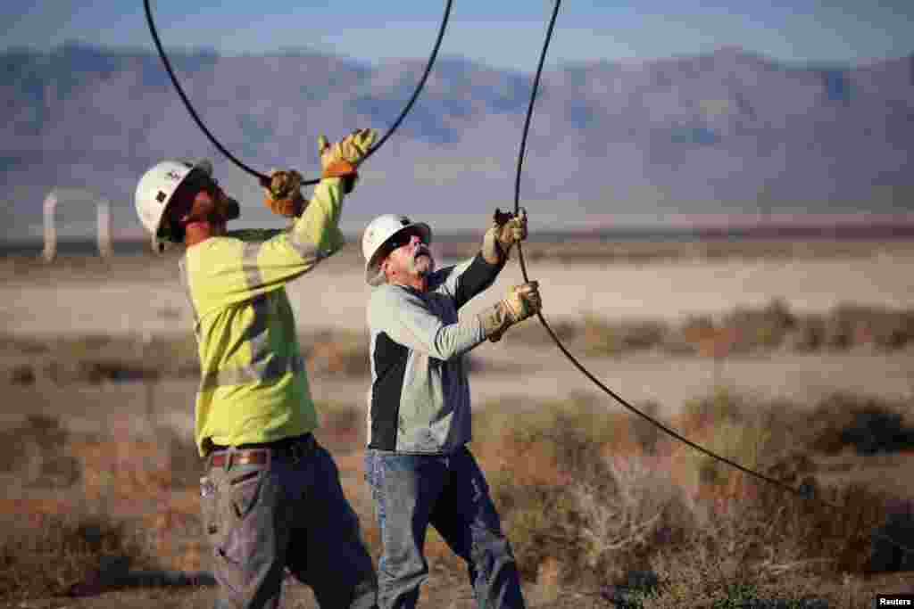 Linemen repair lines that were broken during a powerful earthquake that struck Southern California, near the epicenter, northeast the city of Ridgecrest, California, July 4, 2019.