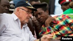 FILE - Patriotic Front (PF) Presidential candidate Edgar Lungu (R) speaks with Acting President Guy Scott at a rally in Lusaka, Jan. 19, 2015. 