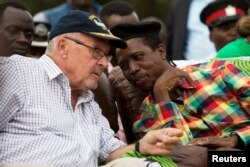 FILE - Edgar Lungu (R) speaks with then-Acting President Guy Scott at a rally in Lusaka, Jan. 19, 2015.