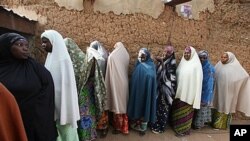 Muslim women line up at a polling place in Daura, Nigeria, Saturday, April 16, 2011