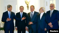 U.S. Secretary of State John Kerry, Britain's Foreign Secretary Philip Hammond, Russian Foreign Minister Sergei Lavrov, Iranian Foreign Minister Javad Zarif and German Foreign Minister Frank-Walter Steinmeier pose for photographers before a meeting in Vie