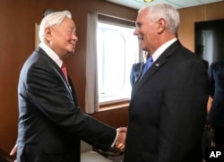 In this photo released by Taiwan's Ministry of Foreign Affairs, Taiwan's special APEC envoy Morris Chang, left, meets with U.S. Vice President Mike Pence on the Pacific Explorer cruise ship on the sidelines of the APEC Summit, Nov. 17, 2018, in Port Mores